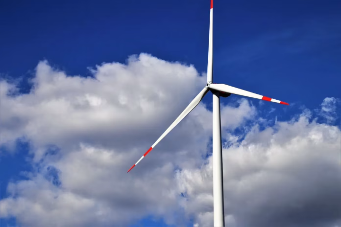 Reforme energetice UE – Turbină eoliană sub cer albastru, simbol al tranziției către surse regenerabile.